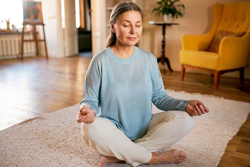 adult woman doing yoga and meditating. 
