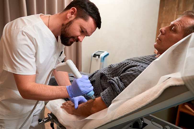 A nurse administers an injection to a man, showcasing Mission's leading pain management experts.