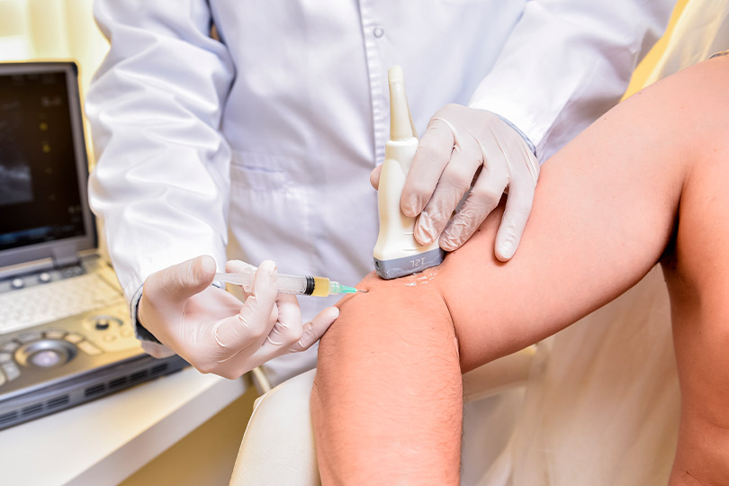 A man receiving an injection in his arm, illustrating a medical procedure related to pain dependency treatment.