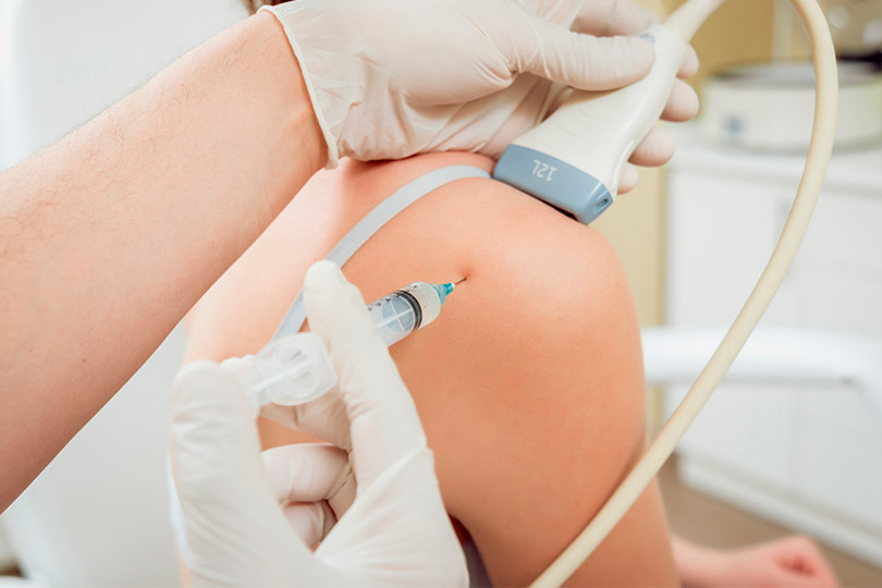 A patient undergoing an injection in the arm, representing pain management services in the RGV area.